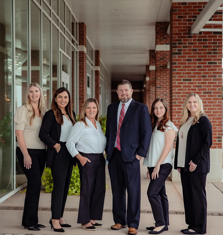 David E. Anderson and the firm's team standing together outside the office