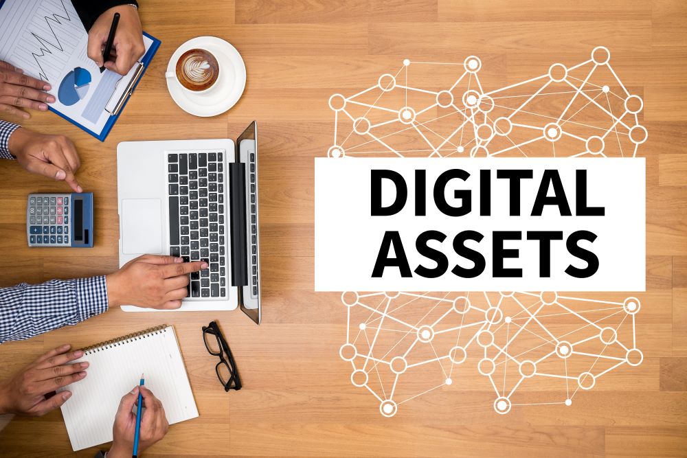 Text saying digital assets with technology on table