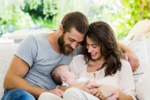 parents holding baby