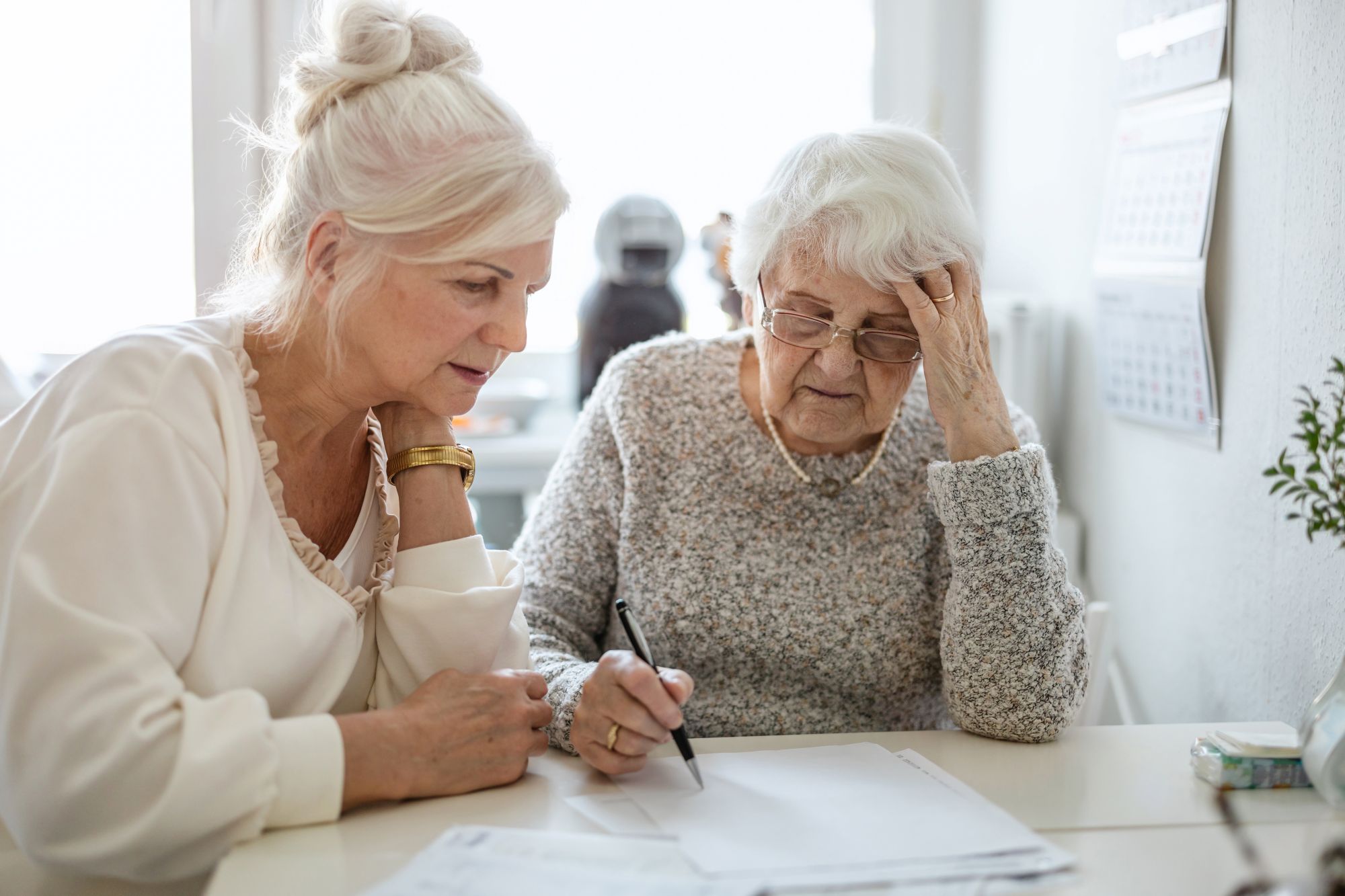 adult child with older parent reviewing paperwork